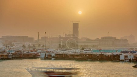 Téléchargez les photos : Coucher de soleil à Doha Bay timelapse avec traditionnels bateaux de pêche boutre en bois. Vue du musée avec Corniche, Doha, Qatar - en image libre de droit