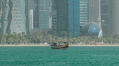 A dhow going to harbour in Doha timelapse, Qatar, with the city's modern skyline in the background at sunny day Tank Top #707670472