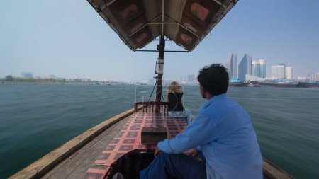 Photo for Excursion on traditional Abra boat at the creek in Dubai, UAE timelapse hyperlapse The cheapest transport. View to side with buildings in Deira district - Royalty Free Image