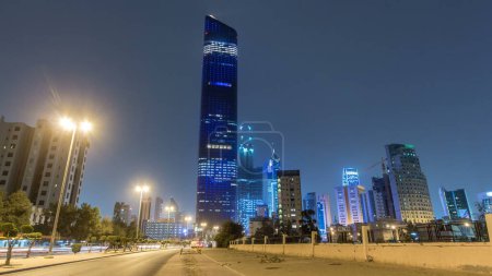 Photo for Tallest building in Kuwait City timelapse hyperlapse - the Al Hamra Tower and other buildings at dusk. View from road with traffic. Kuwait City, Middle East. - Royalty Free Image