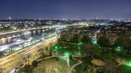 Téléchargez les photos : Aerial view of river Seine with ships from the Eiffel tower night timelapse. Paris, France, Europe. - en image libre de droit