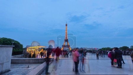 Photo for Eiffel Tower seen from Trocadero day to night transition timelapse hyperlapse in Paris, France. Crowd of people walking on the square with a viewpoint - Royalty Free Image
