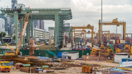 Photo for Port of Singapore timelapse. Bird eye panoramic aerial view of busiest Asian cargo port with hundreds of ships loading export and import goods and thousands of containers in harbor - Royalty Free Image