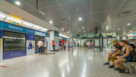 Photo for Passengers waiting for metro train in Singapore Mass Rapid Transit station timelapse. The MRT is the second-oldest metro system in Southeast Asia - Royalty Free Image