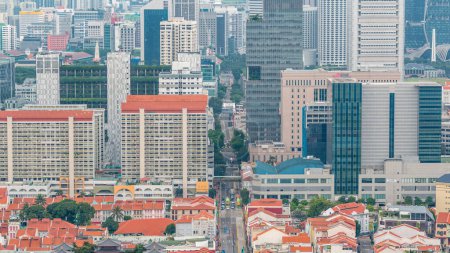 Photo for Aerial view of road traffic in Chinatown and Downtown of Singapore in the evening timelapse from rooftop. Modern towers and skyscrapers - Royalty Free Image