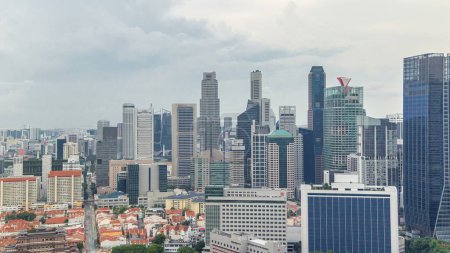 Photo for Aerial panoramic view of Chinatown and Downtown of Singapore in the evening timelapse from rooftop. Modern towers and skyscrapers - Royalty Free Image