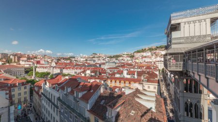 Panorama showing Alfama and Baixa districts of Lisbon aerial timelapse, Portugal, with the castle of Sao Jorge and the panoramic terrace of historical Santa Justa lift, old iron elevator from above