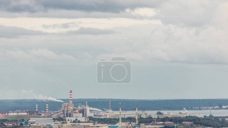 Photo for Thermoelectric Power Plant with smoking pipes aerial timelapse. Deactivated electricity power plant located near the city of Setubal, in Portugal, that used Fuel Oil. Industrial factory with port - Royalty Free Image