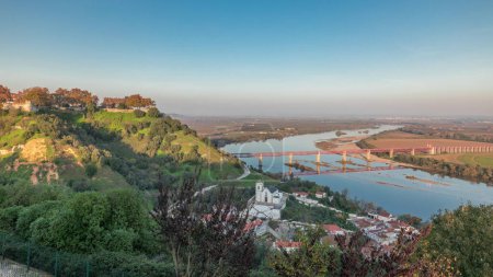Photo for Panorama showing the Castle of Almourol on hill in Santarem aerial timelapse. A medieval castle atop the islet of Almourol in the middle of the Tagus River with bridge over it. Portugal - Royalty Free Image