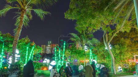 Photo for Pandas and palm trees. Dubai Glow Garden with illuminated trees and sculptures. State of Art architecture featuring environment friendly architecture, creating structures from the recyclable products. - Royalty Free Image