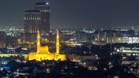 Photo for Dubai skyline with The Jumeirah Mosque illuminated at night timelapse. Dubai, United Arab Emirates. Fireworks over the city - Royalty Free Image