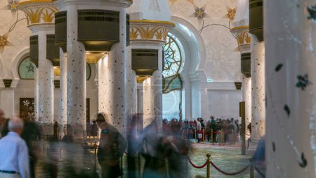 Photo for Magnificent interior of Sheikh Zayed Grand Mosque timelapse with crowd in Abu Dhabi. It is the largest mosque in UAE and the eighth largest mosque in the world. - Royalty Free Image
