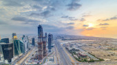 Business bay towers with sunset aerial. Rooftop view of some skyscrapers and new towers under construction. Dubai water canal with bridges and Sheikh Zayed road traffic. Cloudy colorful evening sky Stickers #710556628