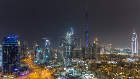 Photo for Dubai downtown cityscape with Burj Khalifa, LightUp light show aerial panoramic timelapse from rooftop. With the largest light and sound show on a single building - Royalty Free Image