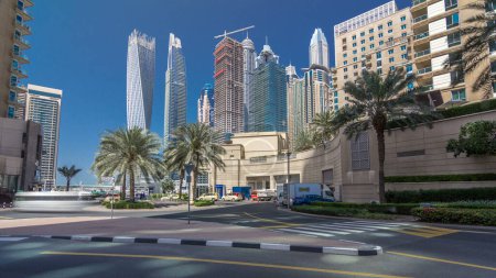 Photo for Panoramic view with modern skyscrapers and walkway of Dubai Marina timelapse hyperlapse, view from crossroad at sunny day. United Arab Emirates - Royalty Free Image