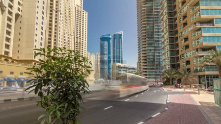 Traffic on the street at Jumeirah Beach Residence and Dubai marina timelapse hyperlapse with skyscrapers, United Arab Emirates. JBR is the largest single phase residential development in the world .
