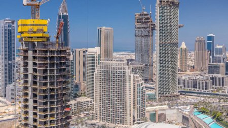 Téléchargez les photos : Dubaï centre-ville à l'heure du jour ensoleillé, bâtiments modernes de luxe et site de construction, paysage urbain futuriste des Émirats arabes unis. Vue aérienne du dessus depuis le gratte-ciel - en image libre de droit