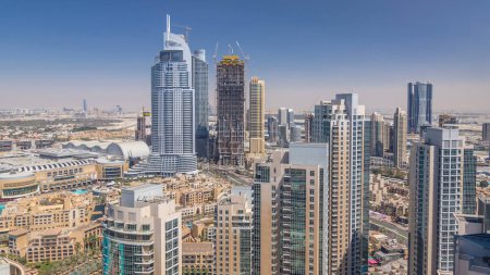 Photo for Dubai downtown at sunny day timelapse, luxury modern buildings, futuristic cityscape of United Arab Emirates. Aerial top view from skyscraper - Royalty Free Image