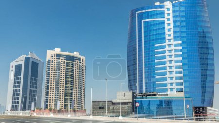 Foto de Vista panorámica del timelapse de la bahía de negocios y el centro de Dubái. Rascacielos modernos y cielo azul en un día soleado. Vista desde el paseo marítimo - Imagen libre de derechos