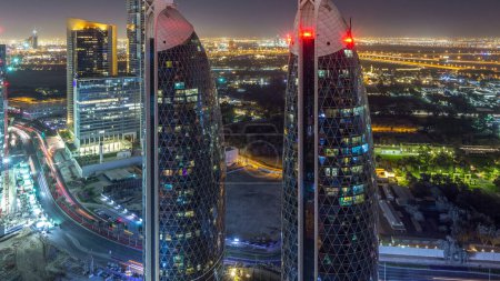 Vue panoramique des bâtiments de Sheikh Zayed Road et de l'espace-temps nocturne DIFC à Dubaï, Émirats arabes unis. gratte-ciel éclairé et maisons dans le centre financier vue aérienne d'en haut