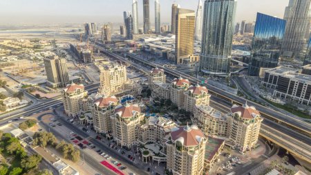 Photo for Dubai downtown skyline at sunset timelapse and road highway traffic near mall and construction site, UAE. Aerial panorama from rooftop of skyscraper with modern towers - Royalty Free Image