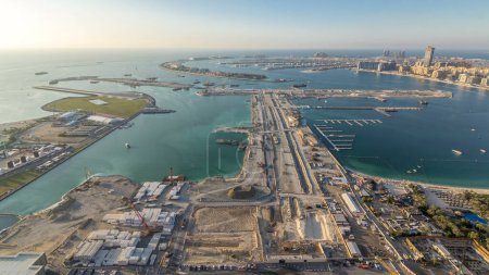 Photo for Aerial view of Palm Jumeirah Island timelapse. Evening top panoramic view with villas, hotels and yachts. Construction process of new cruise terminal - Royalty Free Image