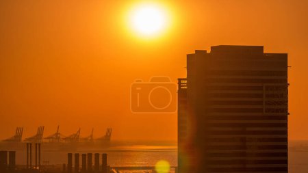 Photo for Dubai Marina with colorful sunset in Dubai aerial timelapse, United Arab Emirates. Top view from JLT with traffic on the road - Royalty Free Image