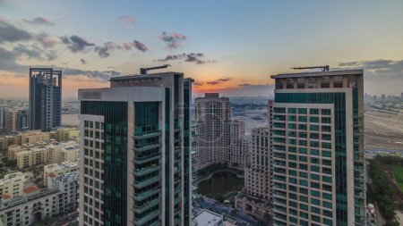 Photo for Sunrise over towers in Greens district aerial view from top timelapse. Residential and office buildings from above near golf course - Royalty Free Image