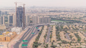 Aerial view of apartment houses and villas in Dubai city timelapse near jumeirah lake towers district, United Arab Emirates. Traffic on the road and overpass. Top view from skyscraper t-shirt #714802330