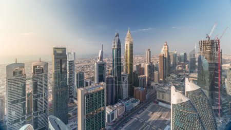 Vista panorámica de los edificios de Sheikh Zayed Road y el timelapse aéreo DIFC en Dubai, Emiratos Árabes Unidos. Modernas torres y rascacielos en el centro financiero y el centro
