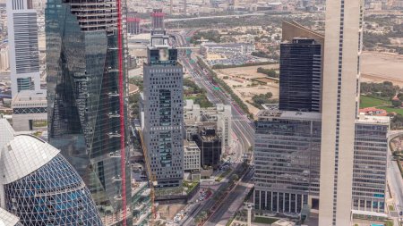 Vista panorámica de los edificios de Sheikh Zayed Road y el timelapse aéreo DIFC en Dubai, Emiratos Árabes Unidos. Modernas torres y rascacielos con sitio de construcción y estacionamiento en el centro financiero y el centro de la ciudad
