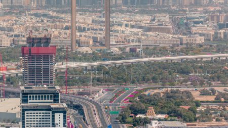 Aerial view to financial and zabeel district timelapse with traffic and under construction building with cranes from downtown Dubai. Deira on a background