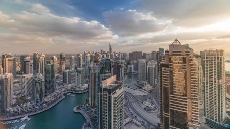 Photo for Dubai Marina skyscrapers and jumeirah lake towers view from the top aerial timelapse in the United Arab Emirates evening view before sunset. Traffic on a road - Royalty Free Image