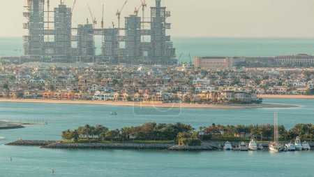 Photo for Palm Jumeirah aerial timelapse during sunset. View from Internet city with construction site and villas. Dubai, United Arab Emirates - Royalty Free Image