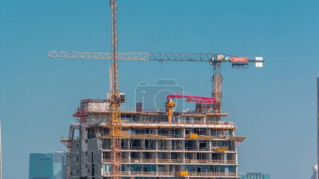 Photo for Aerial view of construction of modern skyscrapers in Business Bay, Dubai, United Arab Emirates, aerial view of a skyscraper under construction with huge cranes - Royalty Free Image