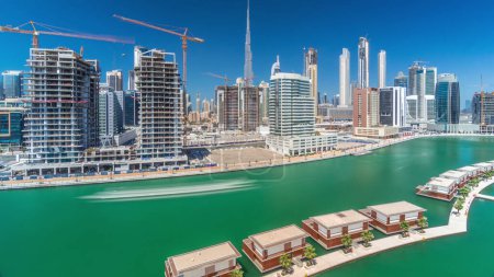 Photo for Aerial panoramic view of skyscrapers in Downtown and Business Bay near wonderful canal with blue sky during all day aerial timelapse, Dubai, United Arab Emirates - Royalty Free Image