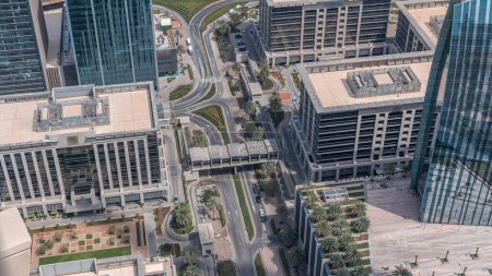 Photo for Dubai downtown street with busy traffic and office buildings around timelapse. Modern towers and footbridge aerial view. - Royalty Free Image