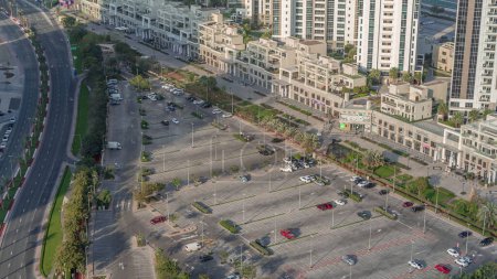 Téléchargez les photos : Vue aérienne voitures complètes à de grands parkings extérieurs timelapse à Dubaï, Émirats arabes unis. Congestion des bureaux et des stationnements résidentiels et stationnement bondé avec d'autres voitures essayez d'entrer et de sortir, trouver un espace de stationnement. - en image libre de droit