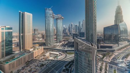 Foto de Vista aérea de nuevas torres y edificios altos con carreteras concurridas timelapse con nubes en el cielo azul en el centro de Dubái desde arriba con tráfico en la autopista, Dubái, Emiratos Árabes Unidos - Imagen libre de derechos