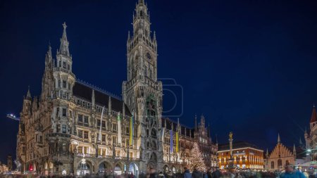 Photo for Marienplazt Old Town Square with New Town Hall day to night transition timelapse hyperlapse. Neues Rathaus and Town Hall Clock Tower Glockenspiel. Munich skyline, downtown cityscape. Bavaria, Germany - Royalty Free Image