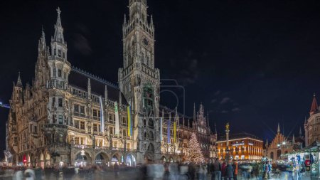 Photo for Marienplazt Old Town Square with Town Hall Clock Tower Glockenspiel night timelapse hyperlapse. Neues Rathaus or New Town Hall. Munich skyline, downtown cityscape. Bavaria, Germany - Royalty Free Image