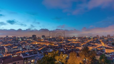 Panorama showing aerial view of downtown of Lisbon day to night transition timelapse, Portugal. Red roofs of typical houses in old town skyline. Historical district after sunset in capital city