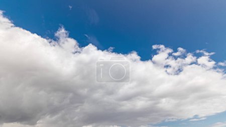 Photo for Blue sky with white cloud closeup motion panoramic timelapse. Movement of clouds before the rain. Dramatic sky and weather change - Royalty Free Image