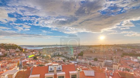 Photo for Lisbon at sunset aerial panorama view of city center with red roofs at Autumn evening timelapse, Portugal. Top view from Miradouro da Nossa Senhora do Monte viewpoint - Royalty Free Image