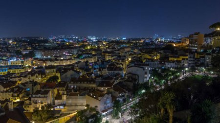 Lisbon aerial panoramic overview of city centre with illuminated buildings at night timelapse, Portugal. Top view from Sophia de Mello Breyner Andresen viewpoint