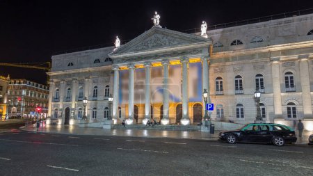 Rossio square in front of the illuminated National Theater Dona Maria II night timelapse hyperlapse in the capital of Portugal. Lisbon