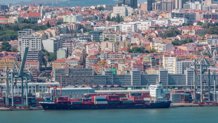 Photo for Panorama of Lisbon historical center aerial timelapse viewed from above the southern margin of the Tagus or Tejo River. Buildings with red roofs and floating ships on water in cargo port - Royalty Free Image