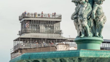Observation deck of the Santa Justa Lift timelapse also called Carmo Lift is an elevator in Lisbon, Portugal. Close up view from rossio square with statues on fountain