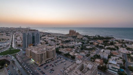 Photo for Cityscape of Ajman and Sharjah day to night timelapse from top with Gulf and buildings. Aerial view from above after sunset - Royalty Free Image