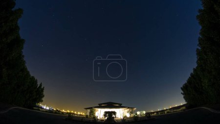 starry night on the desert in UAE timelapse with small house and trees around, fisheye